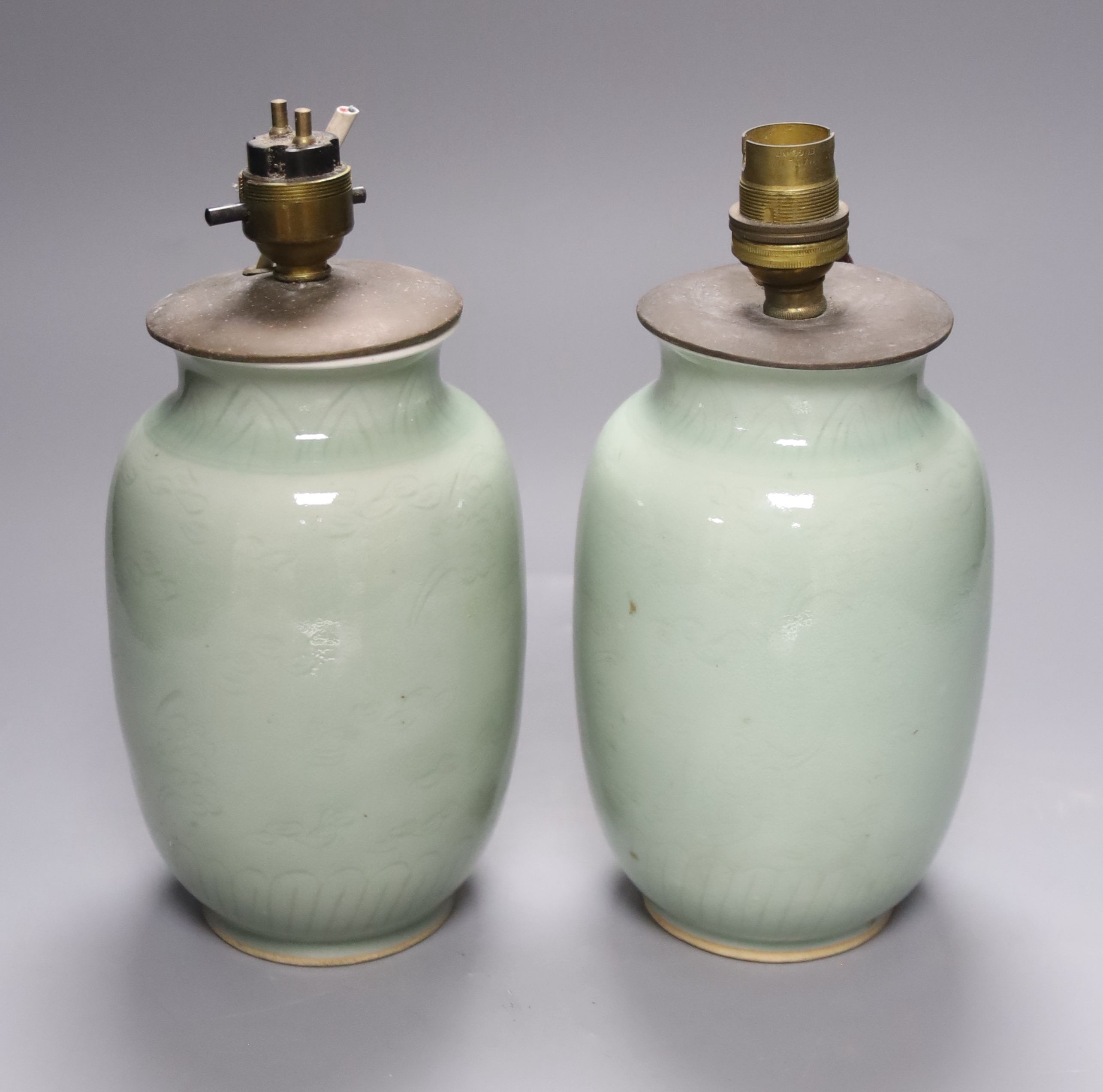 A pair of Chinese celadon vases, now as lamps, Yongzheng mark to base but later, height 19cm excl. electrical fittings